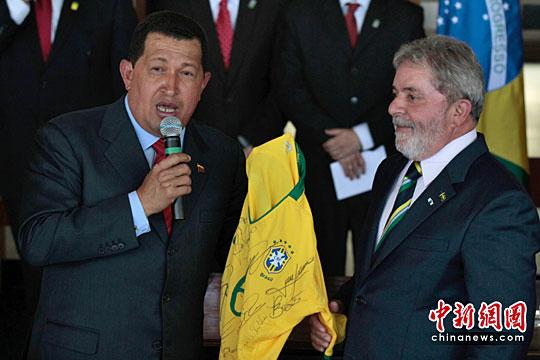资料图：卢拉(右)向委内瑞拉时任总统查韦斯(已故)赠送签名球衣。