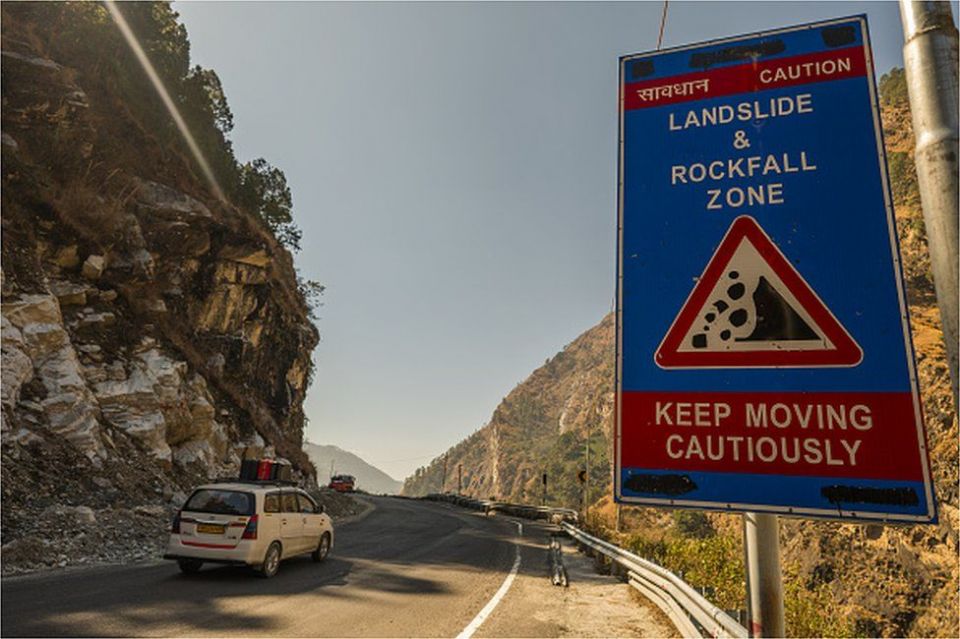 A caution sign for a landslide and rockfall zone posted along a road in Joshimath in Chamoli district, Uttarakhand, India, on Wednesday, Feb. 9, 2022.