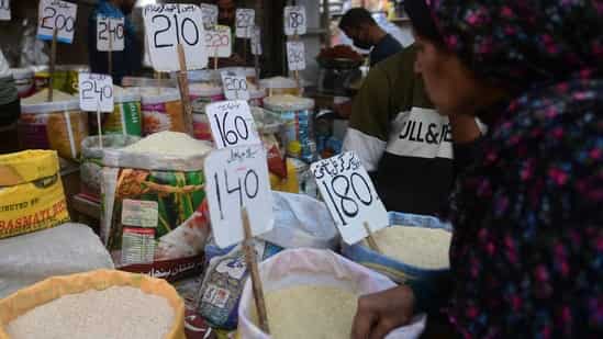 Pakistan Economic Crisis: A woman checks rice prices at a main wholesale market in Karachi. (AFP)