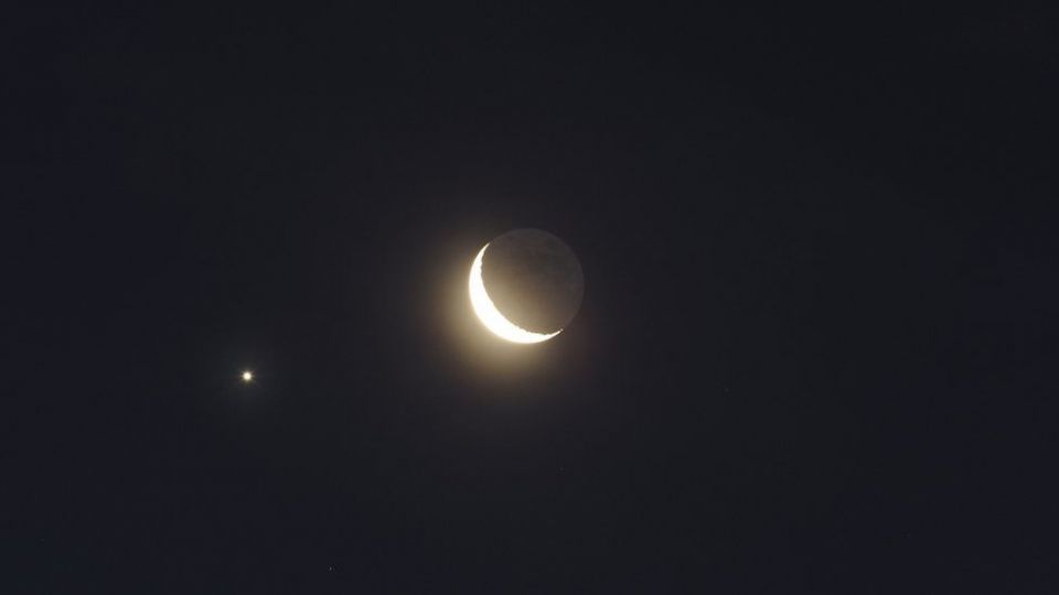 Jupiter captured traveling under the lower left of a Crescent Moon