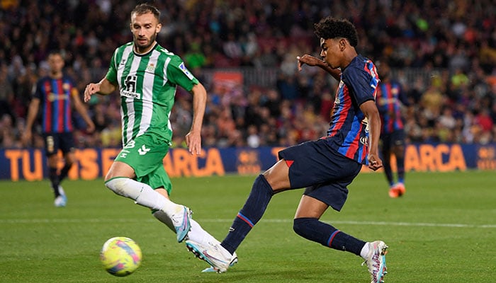 Real Betis Argentinian defender German Pezzela vies with Barcelonas Spanish forward Lamine Yamal (R) during the Spanish league football match between FC Barcelona and Real Betis at the Camp Nou stadium in Barcelona on April 29, 2023. AFP