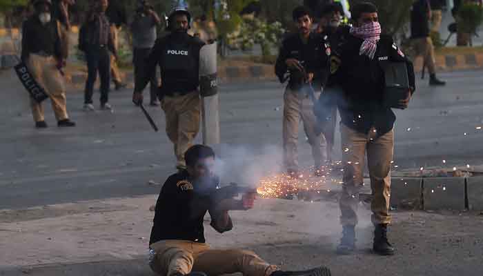 Police fire tear gas shells towards Pakistan Tehreek-e-Insaf (PTI) party activists and supporters of former Pakistan´s Prime Minister Imran during a protest against the arrest of their leader, in Karachi on May 9, 2023. — AFP