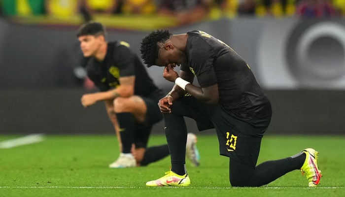 Vinícius Junior takes a knee before the match.—AFP