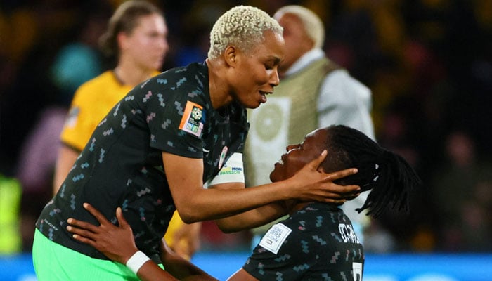 Nigeria´s defender #05 Onome Ebi (L) and Nigeria´s defender #03 Osinachi Ohale celebrate their team´s victory after the end of the Australia and New Zealand 2023 Women´s World Cup Group B football match between Australia and Nigeria at Brisbane Stadium in Brisbane on July 27, 2023.—AFP