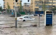 Heaviest rain in a decade kills 11 in Beijing as raging torrents wash away roads and cars