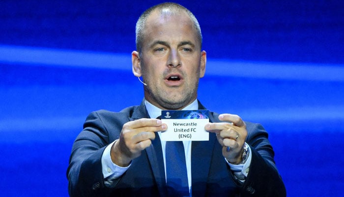 English former football player Joe Cole shows the paper slip of Newcastle United FC during the draw for the 2023/2024 UEFA Champions League football tournament at The Grimaldi Forum in the Principality of Monaco, on August 31, 2023. AFP