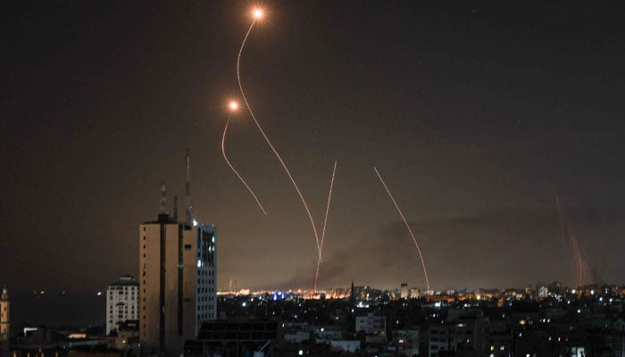An Israeli missile launched from the Iron Dome defence missile system attempts to intercept a rocket, fired from the Gaza Strip, over the city of Netivot in southern Israel on October 8, 2023. — AFP
