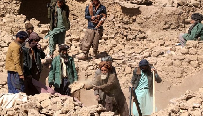 Afghan residents remove debris and search for bodies of victims in the rubble following strong earthquakes in the Zendeh Jan district of Herat province on October 8, 2023. — AFP