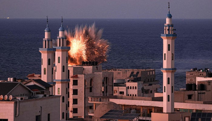 A fireball erupts from an Israeli airstrike in Gaza City on October 12, 2023. — AFP