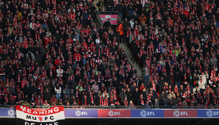 This photo taken on February 26, 2023, shows Manchester United fans watching the English League Cup final football match between Manchester United and Newcastle United at Wembley Stadium, north-west London. — AFP