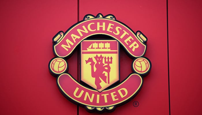 This photo taken on November 23, 2022, shows a Manchester United logo pictured outside of Old Trafford stadium, the home ground of the Manchester United football team, in Manchester, northern England. — AFP