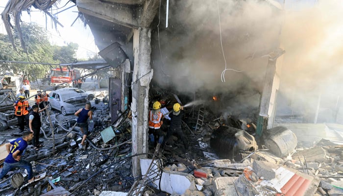 Palestinian rescuers doused a fire at the scene of an Israeli strike in Khan Yunis in the southern Gaza Strip on October 17, 2023. — AFP