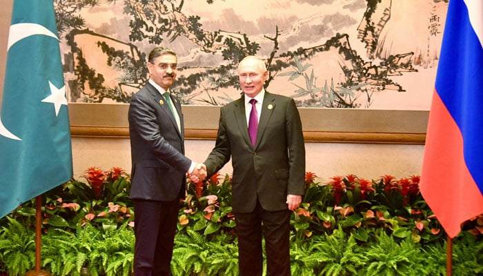 Caretaker Prime Minister Anwaar-ul-Haq Kakar (Left) and Russian President Vladimir Putin shake hands on the sidelines of the Third Belt and Road Forum for International Cooperation in Beijing on Oct 17, 2023. — PM Office