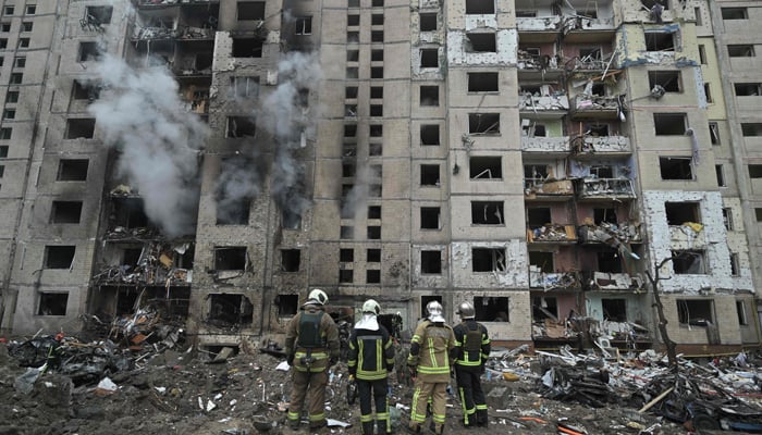 Firefighters work in a multi-storey residential building destroyed by a missile attack in central Kyiv, on January 2, 2024. — AFP