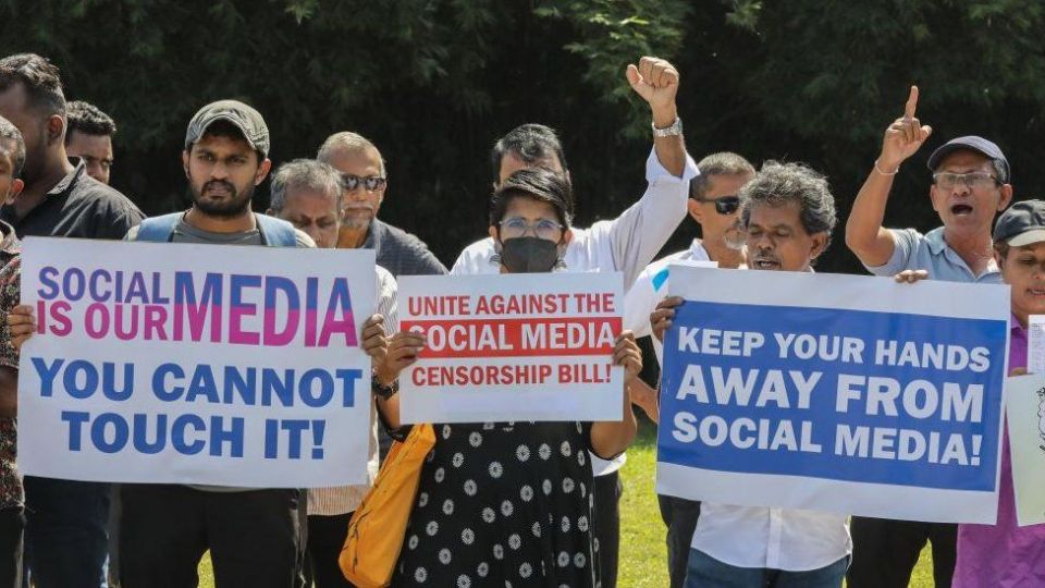 Activists hold placards during a protest against the proposed online safety act near the parliament complex in Colombo, Sri Lanka, 24 January 2024.