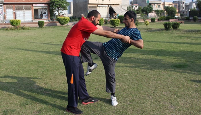 In this undated photo, Ahmad Amin Bodla (right) shows his skills.— Facebook/ Ahmad Amin Bodla