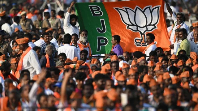 Bharatiya Janata Party supporters hold a party flag during a public meeting attended by Narendra Modi, in Chennai on March 4, 2024. Photo: AFP