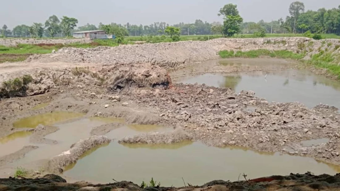 The image shows the land where a pond is being dug up in Jamalpur. Photo: Dhaka Tribune