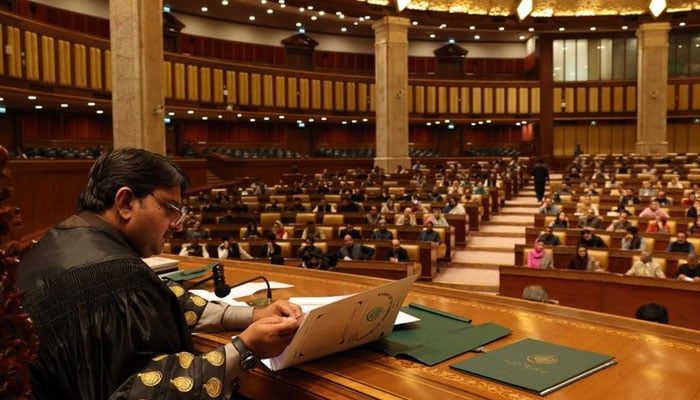 Punjab Assembly Speaker and Acting Punjab Governor Malik Muhammad Ahmad Khan signs documents during an assembly session in this undated image. — Facebook/Malik Muhammad Ahmad Khan/File